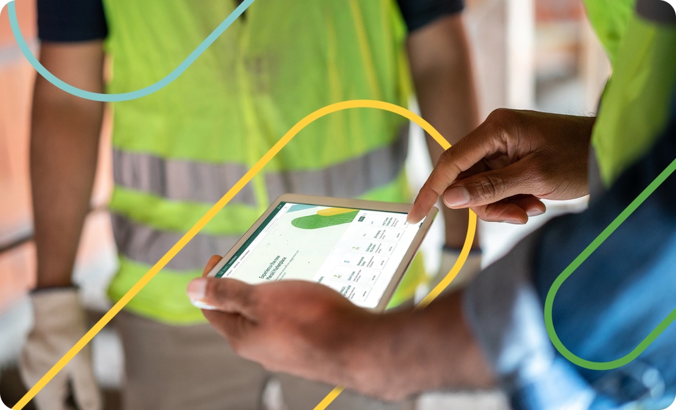 Man in a blue shirt working on a tablet computer